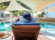 woman-enjoying-relaxing-deck-chair-by-pool