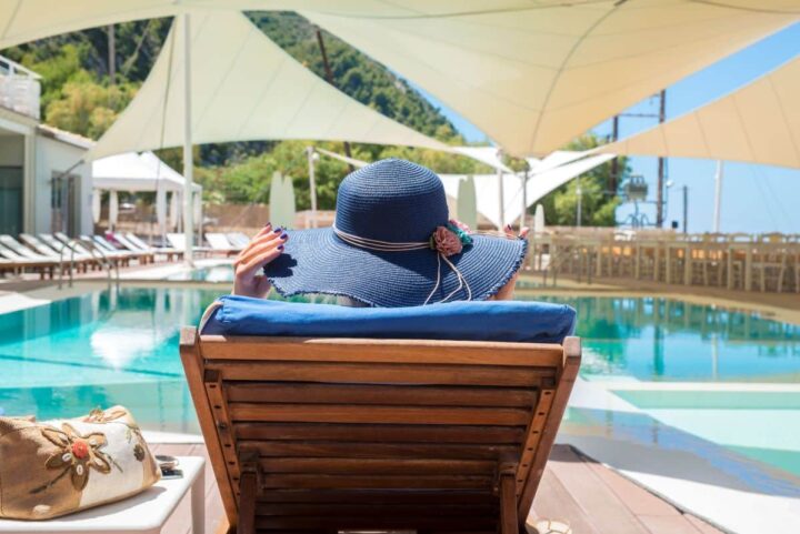 woman-enjoying-relaxing-deck-chair-by-pool